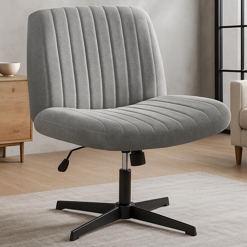 May include: A gray upholstered office chair with a ribbed back and seat. The chair has a black, five-star base and a height adjustment lever. The chair is designed for comfort and style.