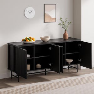 May include: A black sideboard with open doors, revealing interior shelves. The cabinet has a rectangular shape with vertical grooved detailing on the doors. A white clock and artwork hang on the wall above, and a bowl of fruit and other decorative items sit on top.