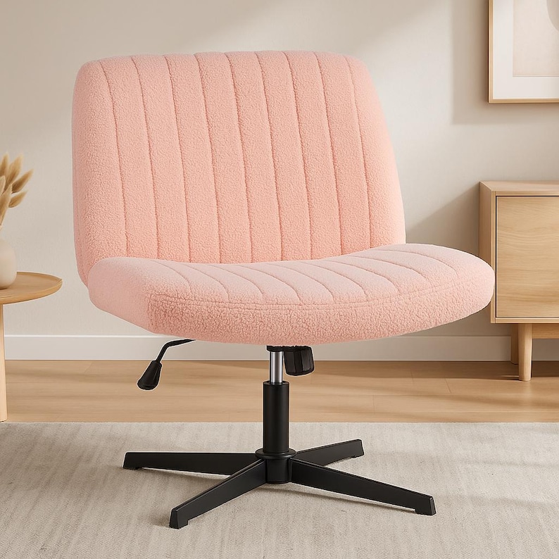 May include: A pink, sherpa-style office chair with a black, five-point base. The chair has a curved seat and back with vertical stitched detailing. The chair's height is adjustable.