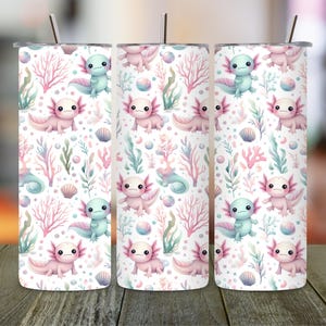 May include: Three stainless steel tumblers with a repeating pattern of axolotls, seaweed, and seashells in pastel pink, blue, and green on a white background. Each tumbler has a silver straw.