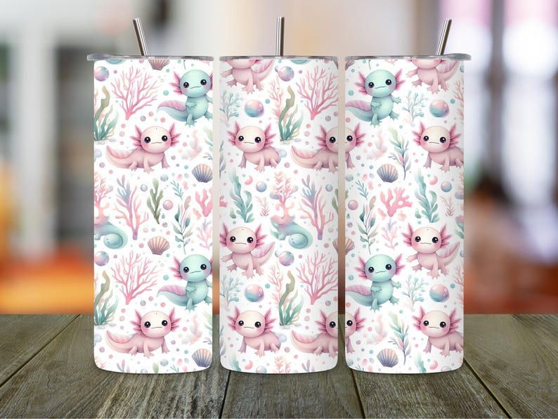 May include: Three stainless steel tumblers with a repeating pattern of axolotls, seaweed, and seashells in pastel pink, blue, and green on a white background. Each tumbler has a silver straw.