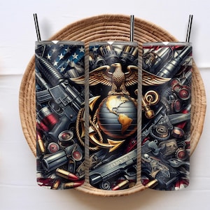 May include: Three stainless steel tumblers with black straws, featuring a design of weapons, an eagle, and a globe. The design incorporates elements of the American flag and military insignia. The tumblers are set on a woven tray.