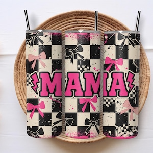 May include: Three insulated tumblers with black straws, featuring a black and white checkered pattern, pink bows, and the word "MAMA" in bold pink letters with a lightning bolt accent. The tumblers are displayed on a woven tray.