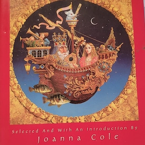 May include: A hardcover book titled "Best Loved Folktales of the World" with a red cover. The cover features a detailed illustration of a ship with figures, fish, and the text "Selected And With An Introduction By Joanna Cole."
