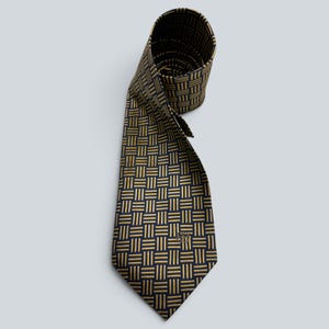 May include: A necktie featuring a dark navy blue background with a repeating gold geometric pattern of small vertical and horizontal lines. The lower portion of the tie displays a small, embroidered gold monogram logo near the pointed tip.