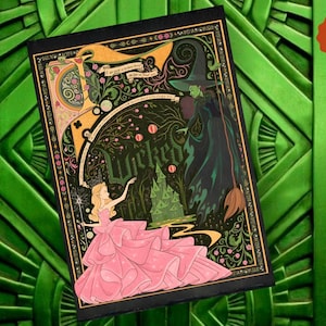 May include: A decorative art print featuring characters from the musical "Wicked." The illustration shows a woman in a pink dress and the Wicked Witch of the West. The word "Wicked" is prominently displayed. The background is dark green.