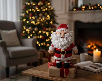 May include: A crocheted Santa Claus figure with a red hat and suit, white beard, and black belt. The Santa Claus is standing on a wrapped gift box with a red ribbon, with a Christmas tree and fireplace in the background.