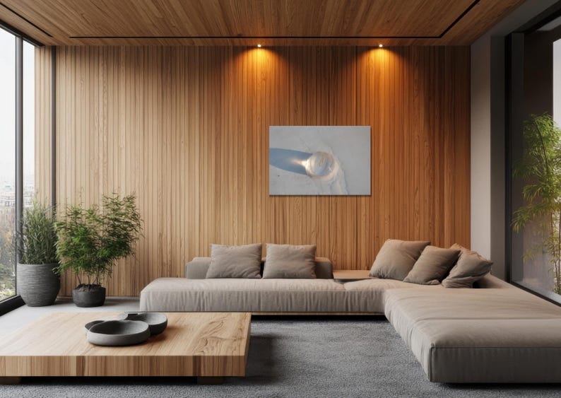 May include: A modern living room with a light brown sectional sofa, a wooden coffee table, and a wooden accent wall. A framed picture hangs on the wall. Potted plants are placed near a large window.