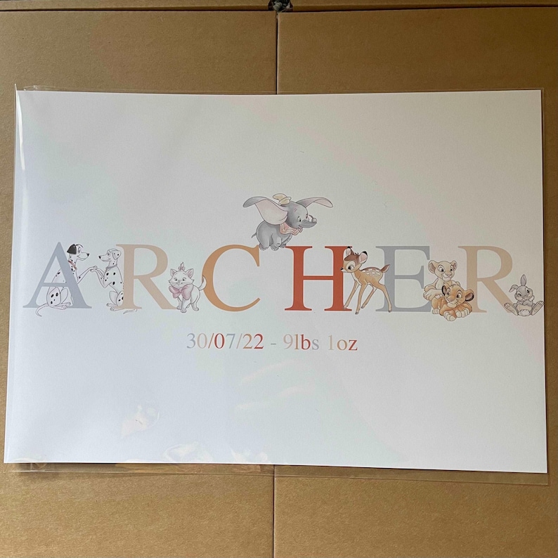 K&ouml;nnte beinhalten: Personalisierter Baby-Namensdruck mit dem Namen "ARCHER" in bunten Buchstaben, verziert mit Disney-Charakterillustrationen. Der Druck enth&auml;lt das Datum 30.07.22 und das Gewicht 4,1 kg, was ihn zu einem einzigartigen Andenken macht.
