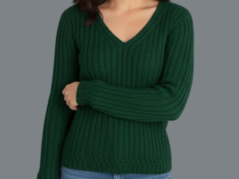 May include: A dark green, ribbed knit sweater with a V-neck. The long-sleeved top is made of a soft material and is a solid color. The sweater is a classic style.