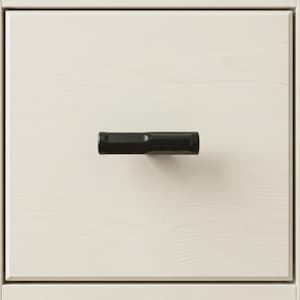 May include: Close-up of a white wooden drawer with a black, geometric handle. The handle is horizontal and centered, providing a modern contrast to the light wood grain.