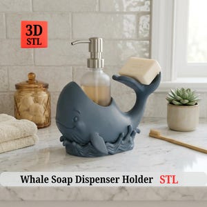 May include: A blue whale-shaped soap dispenser holder with a silver pump dispenser and a bar of soap. The holder has a whimsical design with a smiling face and wave details. The text "Whale Soap Dispenser Holder STL" is at the bottom.