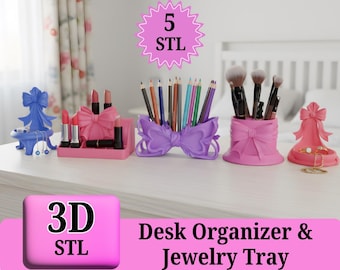 May include: A collection of pink and purple 3D-printed desk organizers and jewelry trays. The set includes a lipstick holder, pencil holder, brush holder, and jewelry tray, all with bow-shaped designs. The image also includes the text "3D STL" and "Desk Organizer & Jewelry Tray."