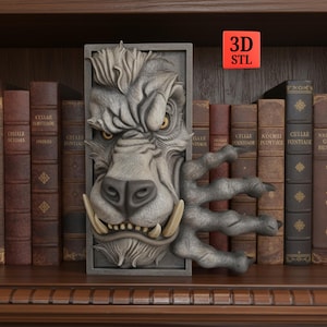 May include: A gray, 3D-printed wall art piece featuring a detailed, stylized wolf head with large tusks and a clawed hand. The artwork is set against a backdrop of antique books on a wooden shelf. The text "3D STL" is visible.