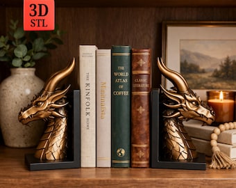 May include: Dragon head bookends in antique gold finish, flanking a row of books on a wooden shelf. The bookends have a detailed dragon design with horns and scales. The books include titles like "The Kinfolk Home" and "The World Atlas of Coffee".