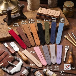 May include: A collection of colorful leather watch straps in various shades, including red, brown, yellow, black, green, and blue. The straps are arranged on a wooden surface with tools and materials used in leather crafting, such as edge paints and burnishing compounds.
