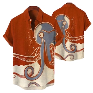 Può includere: Camicia a maniche corte con un design a polpo. La camicia ha uno sfondo color ruggine con una sezione inferiore color crema. L'illustrazione del polpo è blu e arancione. Anche il retro della camicia presenta il design del polpo.