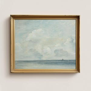May include: A framed painting of a seascape with a light blue sky and white clouds. The sea is a dark blue and there is a small island in the distance.