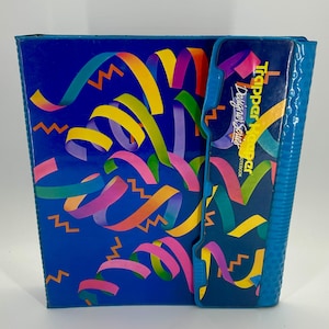 May include: A white ceramic mug with a black handle and the text "But First, Coffee" in a handwritten style. The mug is on a white surface. The mug is approximately 4 inches tall.