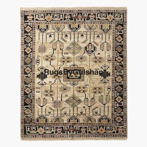 May include: A rectangular beige rug with an intricate geometric pattern. The rug features a central design with repeating shapes in black, green, and brown, framed by a detailed border. The text "RugsByGilshan" is visible on the rug.
