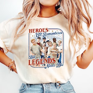 May include: A white ceramic mug with a black handle and the text "But First, Coffee" in a handwritten style. The mug is on a white surface. The mug is approximately 4 inches tall.