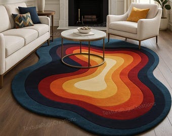 May include: A colorful, abstract area rug with a unique, wavy shape. The rug features concentric bands of color, including shades of blue, red, orange, and yellow. The rug is placed in a living room setting with a sofa, armchair, and coffee table.
