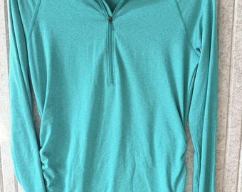 Sudadera The North Face Flash Dry para mujer, ideal para senderismo y actividades al aire libre, color verde azulado.