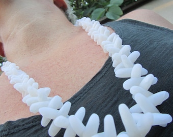 white semi-translucent luminescent anemone-shaped polymer beaded necklace