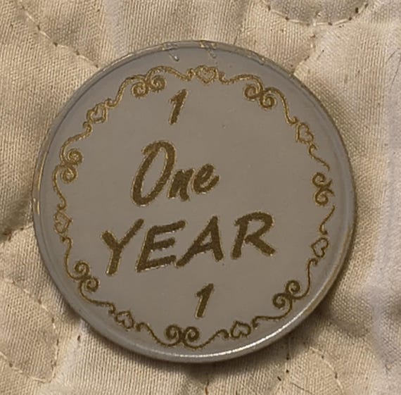 1 year sobriety coin made from a feau gold coin painted gray then engraved to show the gold underneath. I can paint these any color.