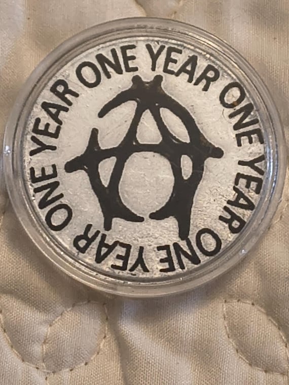 1 year sobriety coin made from a feau gold coin engraved.  I can paint them any color. I ship for exactly what it costs me.
