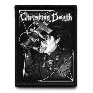 May include: Black and white patch featuring the band name "Christian Death" in a gothic font. The image depicts a person singing into a microphone, with a cross and other religious symbols. The patch has a black border.