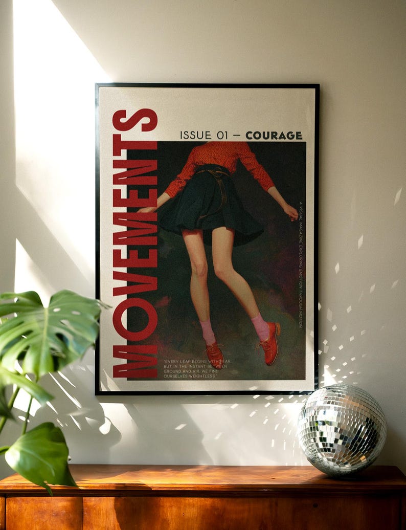 May include: A framed poster with the word "MOVEMENTS" in large red letters. The poster features an illustration of a person in a red top and dark skirt. Text reads "ISSUE 01 - COURAGE". A disco ball sits on a wooden surface.