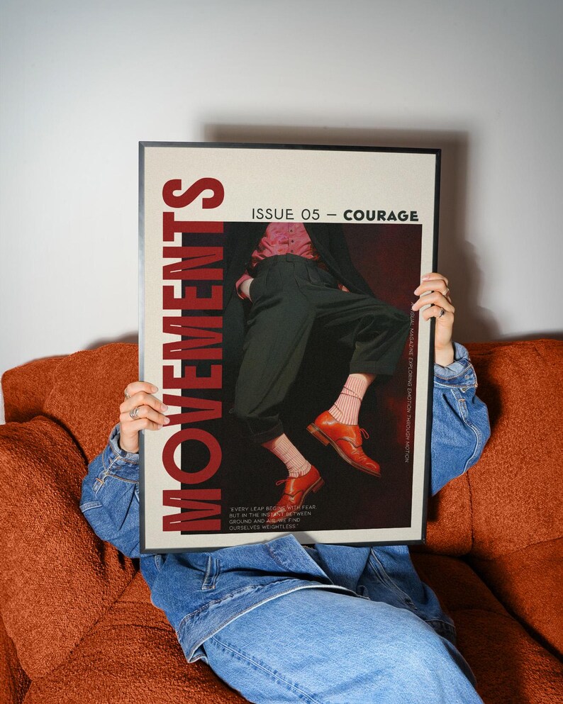 May include: A framed magazine cover with the word "MOVEMENTS" in large red letters. The cover features a person in dark pants, a pink shirt, and orange shoes. The text "ISSUE 05 - COURAGE" is also visible.