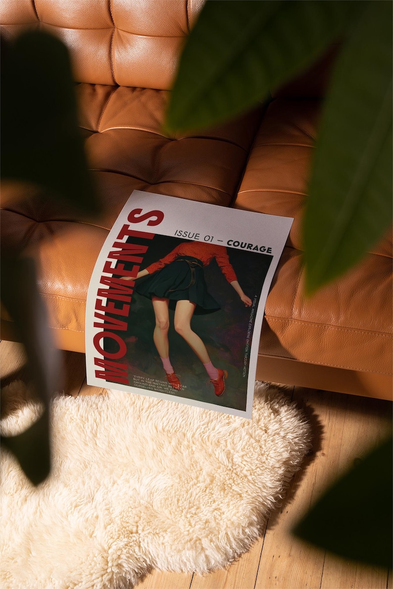 May include: A magazine titled "MOVEMENTS" with the text "ISSUE 01 - COURAGE" is displayed on a brown leather couch. The magazine features an illustration of a person wearing a red top, a black skirt, and red shoes. The magazine rests on a white, fluffy rug.