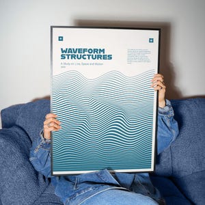 May include: A framed poster with the title "WAVEFORM STRUCTURES" in teal and white, featuring a wavy line design. The poster is held by a person wearing a denim jacket and jeans, sitting on a blue sofa.