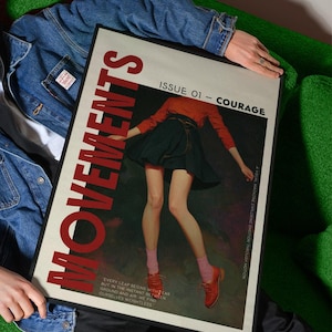 May include: A framed magazine cover with the word "MOVEMENTS" in large red letters. The cover features an illustration of a person in a red top and black skirt. The text "ISSUE 01 - COURAGE" is also visible.