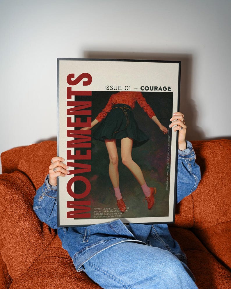 May include: A framed magazine cover with the word "MOVEMENTS" in red. The cover features an illustration of a person in a red top and black skirt. The text "ISSUE 01 - COURAGE" is also visible.