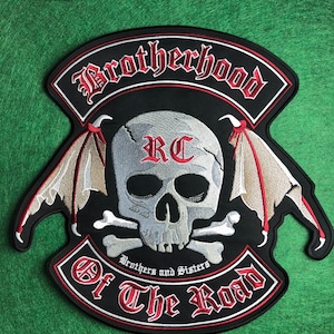 May include: Black embroidered patch with a skull, crossbones, and bat wings design. The patch features the words "Brotherhood Of The Road" in red and white lettering. The letters "RC" are on the skull.