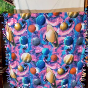 Galaxy and planets knotted blanket