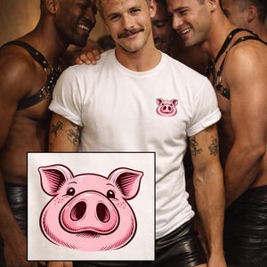 May include: White t-shirt with a pink pig graphic. The t-shirt is worn by a person with a mustache, surrounded by other people. The pig graphic is a close-up of a pig's face with pink and black details.