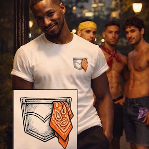 May include: White t-shirt with a pocket design featuring a denim pocket outline and an orange paisley bandana. The image shows a group of people in an outdoor setting at night.
