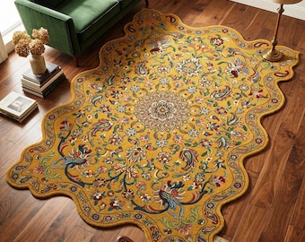 May include: Mustard yellow area rug with a floral and paisley design. The rug has a scalloped edge and features a central medallion pattern with blue, red, and green accents. The rug is placed on a hardwood floor.