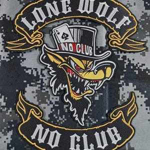 May include: An embroidered patch featuring a wolf wearing a top hat and holding a playing card. The patch reads "LONE WOLF" above and "NO CLUB" below, set against a digital camouflage background in shades of grey and black.
