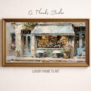 Può includere: Dipinto a olio di una panetteria francese con tenda da sole blu, tavoli e sedie. L'opera è incorniciata in una cornice color oro. I testi "G, Thanks Studio" e "LUXURY FRAME TV ART" sono visibili.