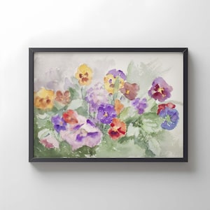 Puede incluir: Una pintura de acuarela enmarcada que representa un grupo de pensamientos en tonos amarillos, morados, rojos y blancos. Las flores están representadas con pinceladas suaves y difuminadas sobre un fondo de lavado verde claro y gris, en un marco negro.