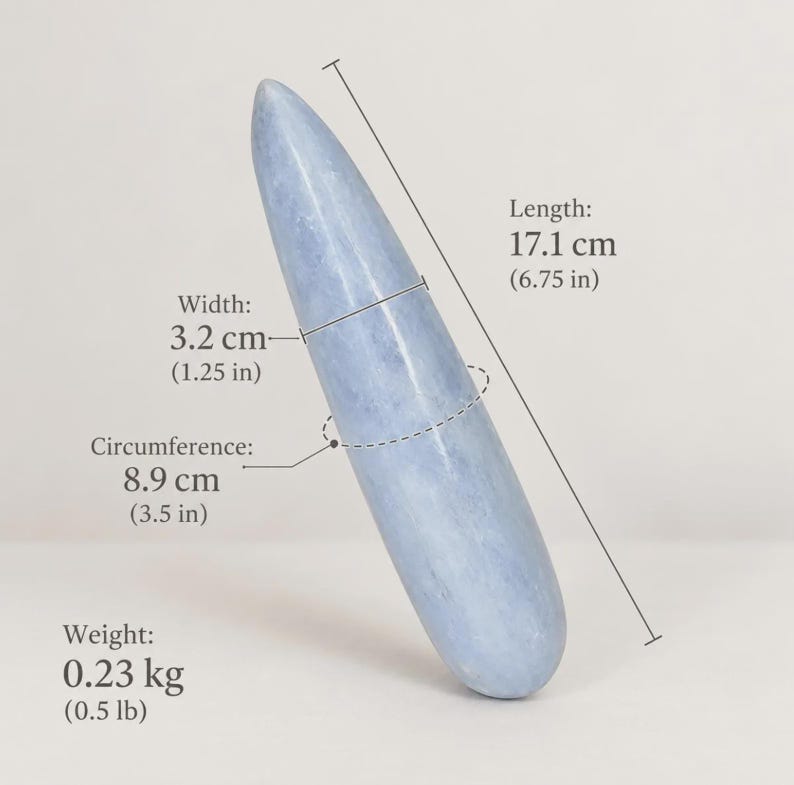 May include: A smooth, light blue, tapered stone object with a rounded tip. Text indicates a length of 6.75 inches, a width of 1.25 inches, a circumference of 3.5 inches, and a weight of 0.5 pounds, providing clear physical specifications.