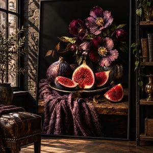 May include: A framed still life painting featuring dark purple flowers and sliced figs on a plate. The composition includes a whole fig, several cut fig segments with visible red interiors, and a draped purple fabric, all set against a black background.