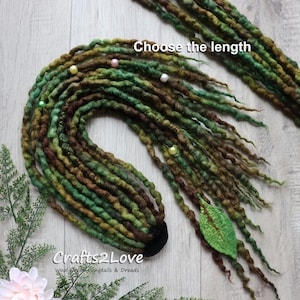 May include: Handmade wool dreadlocks in shades of green and brown, decorated with small beads and a felt leaf. The text "Choose the length" is visible. The product is from Crafts2Love, specializing in wool ponytails and dreads.
