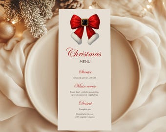 May include: A Christmas menu card featuring a red bow with white trim and a black buckle. The card reads "Christmas MENU" in elegant script, with menu items listed below, including smoked salmon, roast beef, and pumpkin pie. The card is placed on a white plate.