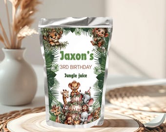 May include: A silver pouch with the text "Jaxon's 3rd Birthday Jungle Juice" and a jungle animal theme. The pouch features illustrations of a lion, monkey, giraffe, elephant, and other animals. The pouch is displayed on a wooden slice.
